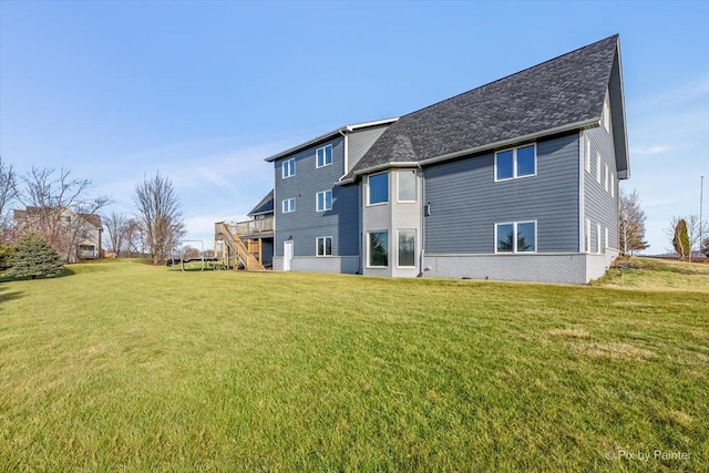 back of house featuring a wooden deck and a lawn