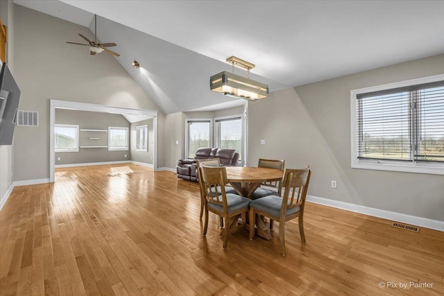 dining space featuring lofted ceiling, ceiling fan, and light wood-type flooring