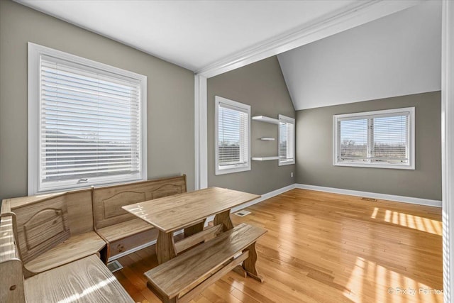 dining area with wood-type flooring and lofted ceiling