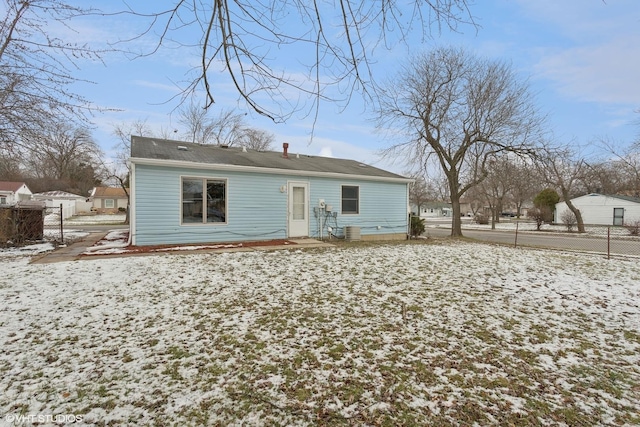 view of snow covered back of property