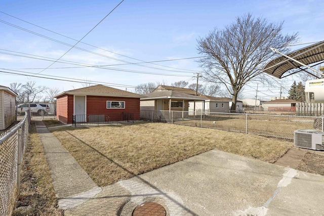 exterior space featuring central AC unit, an outdoor structure, and a front lawn