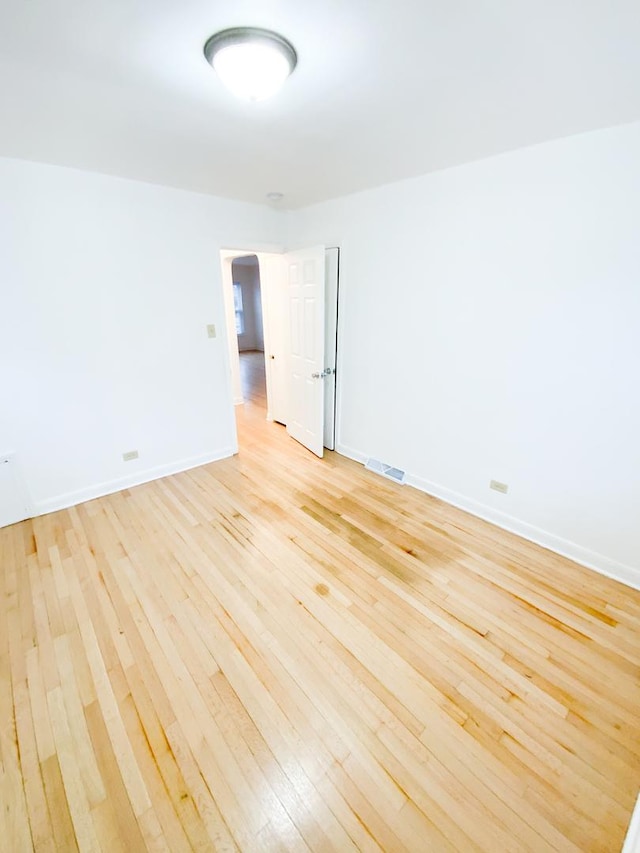 spare room with light wood-type flooring