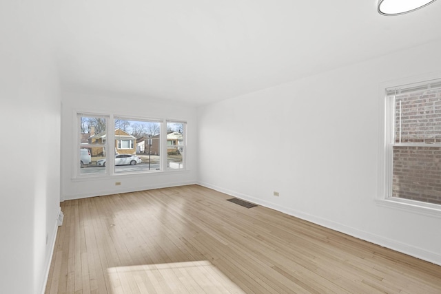 spare room featuring light wood-type flooring