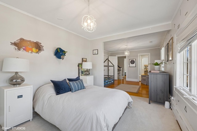 bedroom featuring an inviting chandelier, multiple windows, baseboards, and crown molding