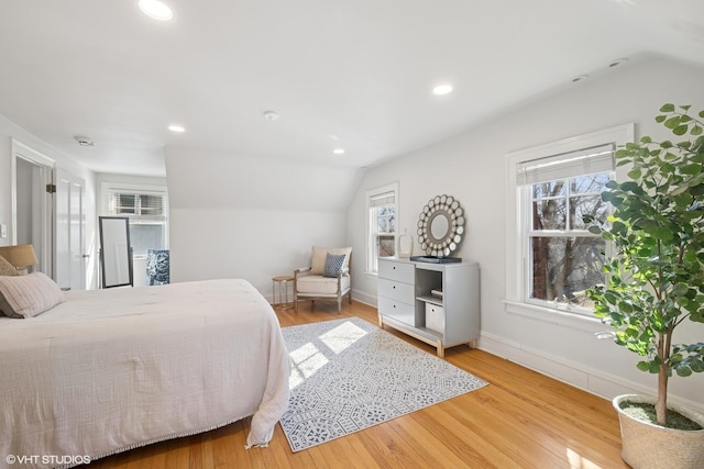 bedroom with lofted ceiling, recessed lighting, wood finished floors, and baseboards