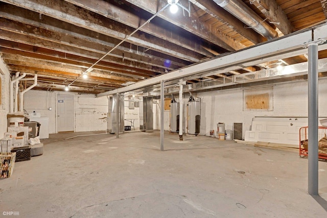 basement featuring gas water heater and washer / dryer