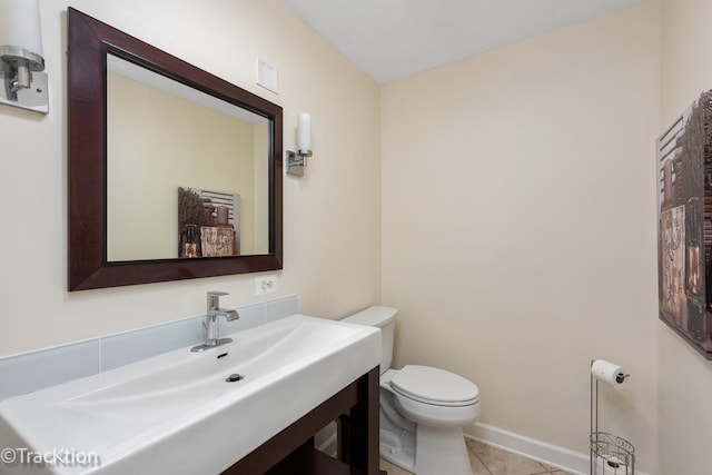 bathroom featuring sink, tile patterned flooring, and toilet