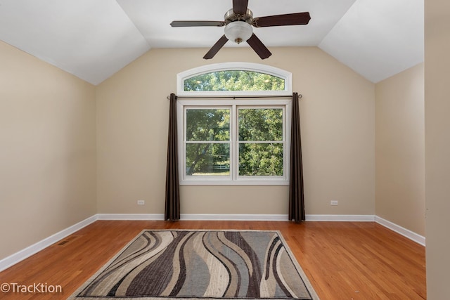 empty room with ceiling fan, light hardwood / wood-style flooring, and lofted ceiling