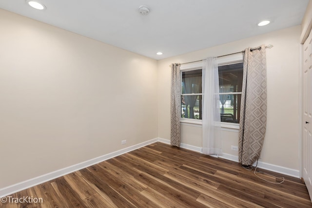 spare room with dark wood-type flooring