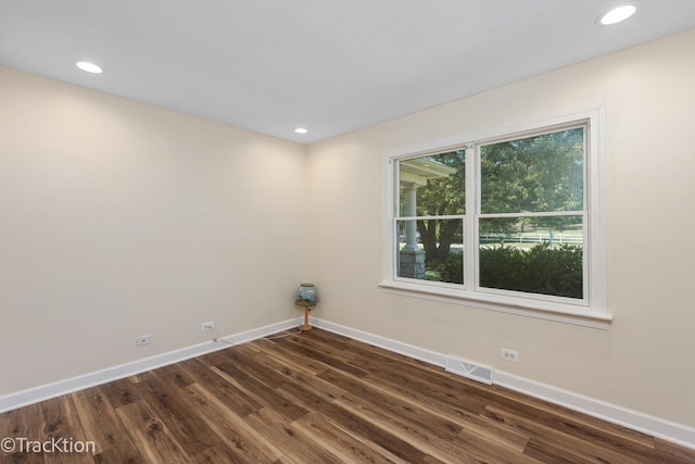 spare room featuring dark hardwood / wood-style flooring