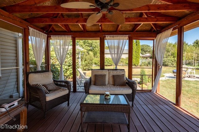 unfurnished sunroom with ceiling fan and lofted ceiling