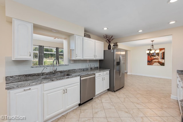 kitchen with white cabinets, appliances with stainless steel finishes, decorative backsplash, and sink