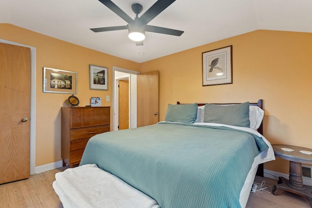 bedroom with ceiling fan, light hardwood / wood-style flooring, and lofted ceiling