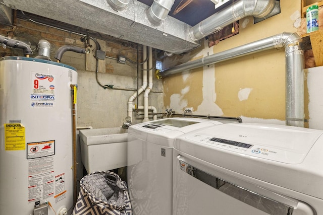 laundry room featuring gas water heater and separate washer and dryer