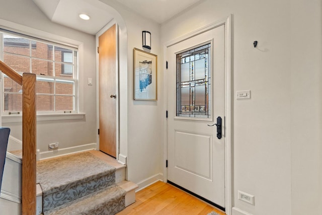 doorway with light hardwood / wood-style flooring and a healthy amount of sunlight