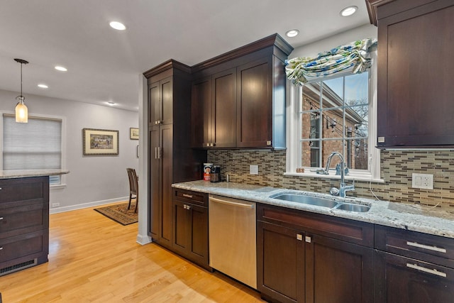 kitchen with dishwasher, sink, a healthy amount of sunlight, and decorative light fixtures