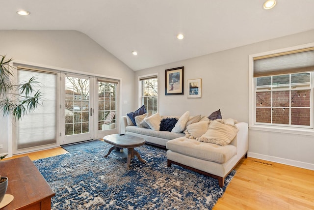 living room featuring wood-type flooring and lofted ceiling