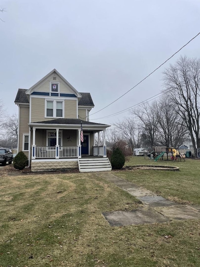 view of front facade featuring a front yard, a porch, and a playground