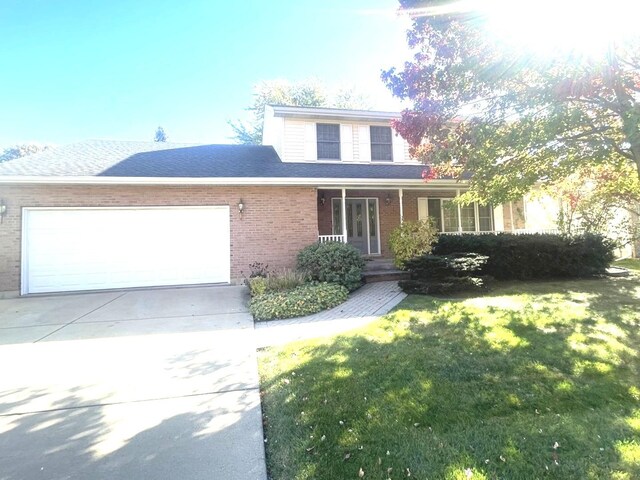 front facade featuring a garage and a front lawn