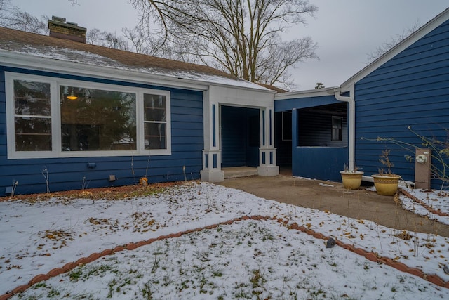 view of snow covered property entrance