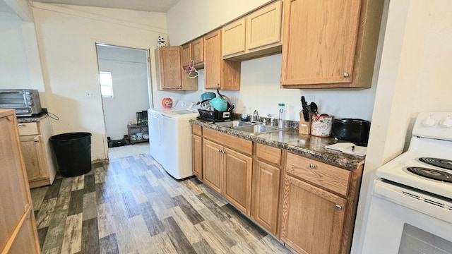 kitchen featuring electric range, sink, washer / clothes dryer, and hardwood / wood-style floors