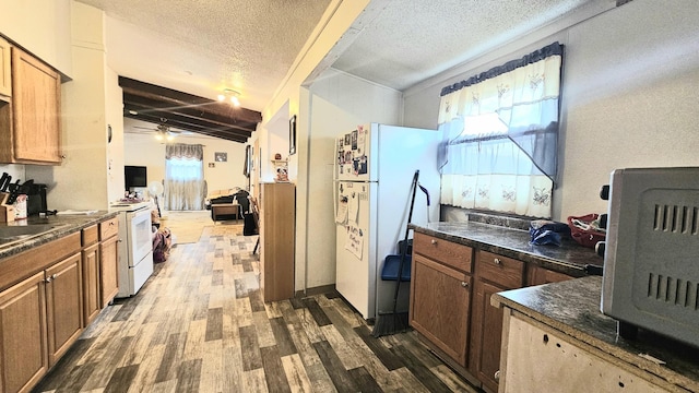 kitchen featuring ceiling fan, wood-type flooring, a textured ceiling, vaulted ceiling, and white appliances