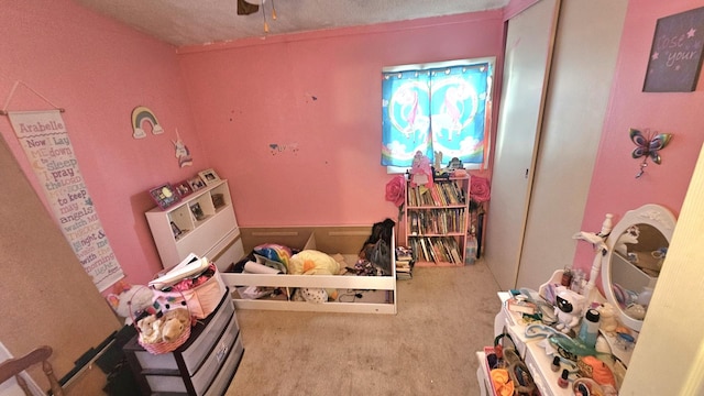 bedroom featuring carpet flooring and a textured ceiling