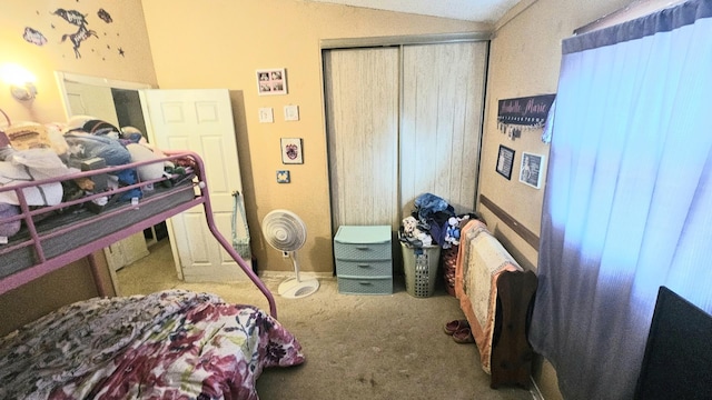 carpeted bedroom featuring vaulted ceiling and a closet