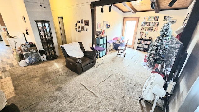 living area featuring lofted ceiling with beams, carpet floors, and wood ceiling