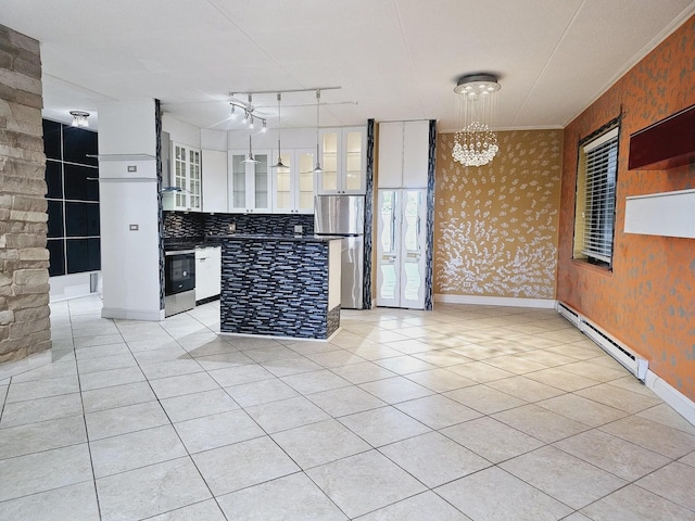 kitchen featuring a baseboard radiator, tasteful backsplash, decorative light fixtures, white cabinetry, and stainless steel refrigerator