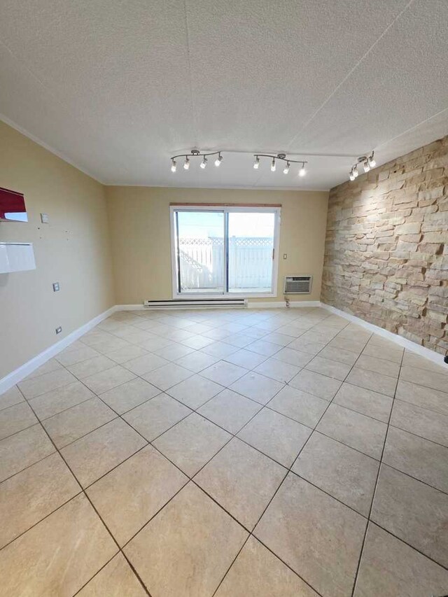 unfurnished living room featuring light tile patterned floors, baseboards, a baseboard radiator, a wall mounted air conditioner, and a textured ceiling