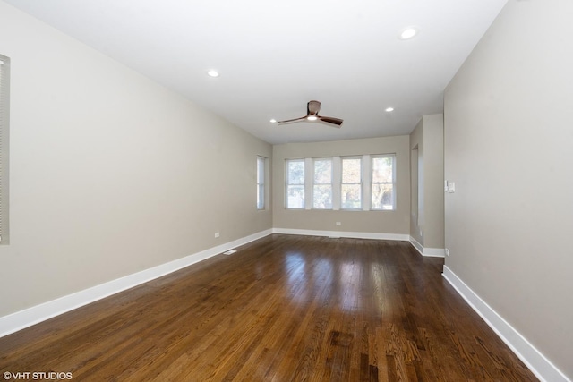 empty room with dark hardwood / wood-style flooring and ceiling fan