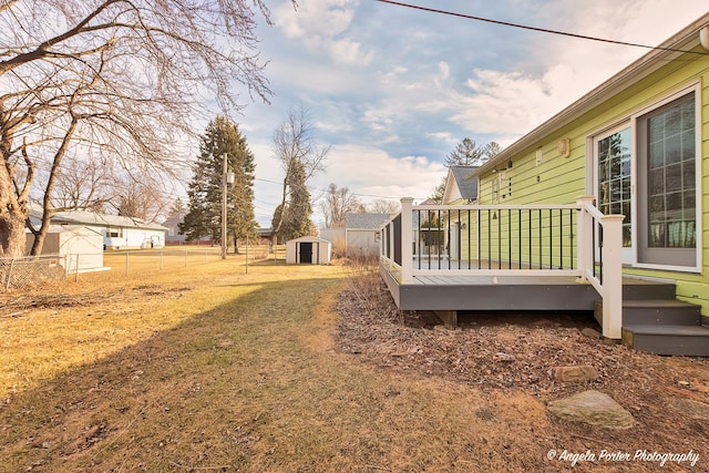 view of yard featuring a storage unit and a deck