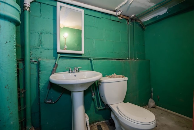 bathroom featuring concrete floors and toilet