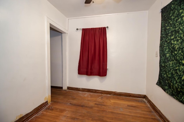 empty room with hardwood / wood-style flooring and ceiling fan