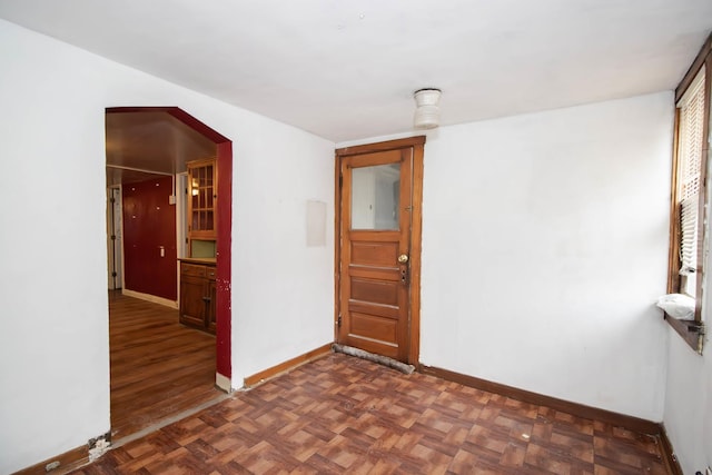 entryway with dark parquet floors