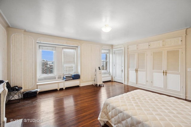 bedroom with dark wood-type flooring