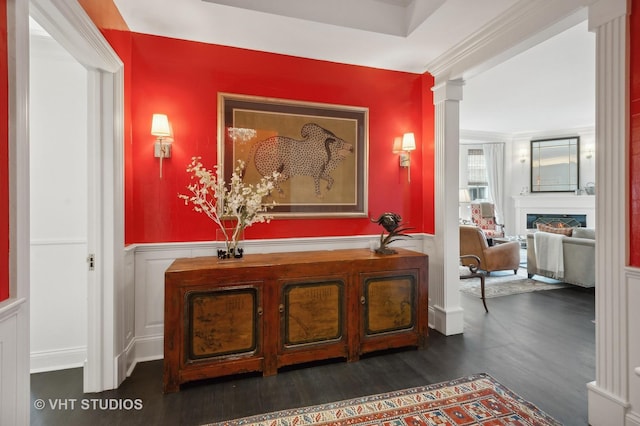 hall with dark hardwood / wood-style flooring and decorative columns