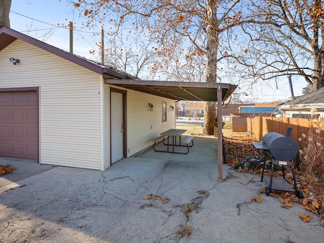 view of patio featuring a carport, a garage, and grilling area