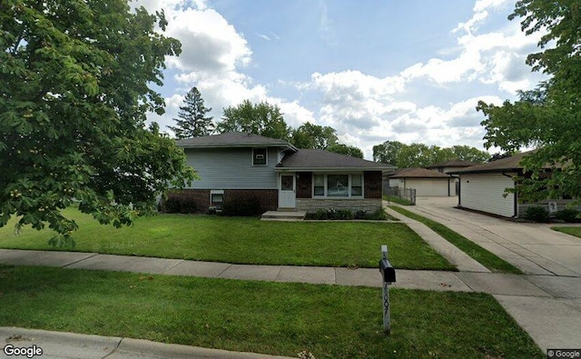 tri-level home featuring a front yard and a garage