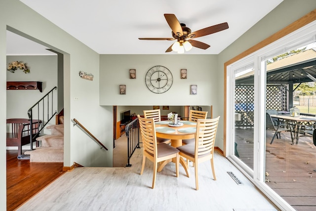 dining room with hardwood / wood-style flooring and ceiling fan