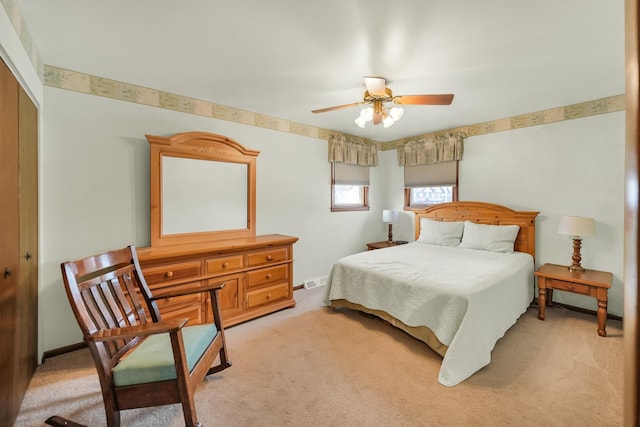 carpeted bedroom with ceiling fan and a closet