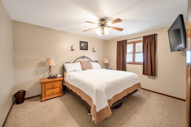 bedroom with ceiling fan and light carpet