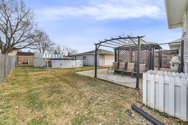 view of yard with a pergola, a patio, and a covered pool