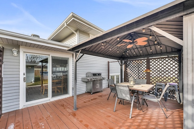 wooden deck with a gazebo and area for grilling