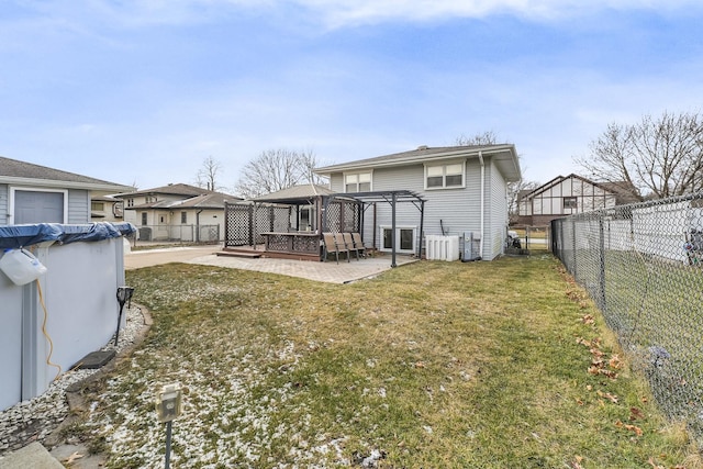 rear view of property featuring a gazebo, a pergola, a lawn, and a patio