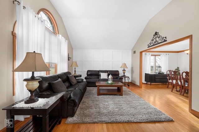 living room with light hardwood / wood-style flooring and lofted ceiling