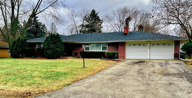 single story home featuring a garage and a front lawn