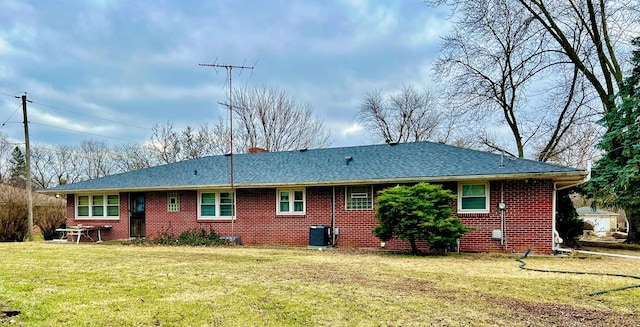 back of house with a lawn and central air condition unit