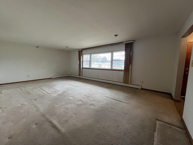 carpeted empty room with baseboard heating